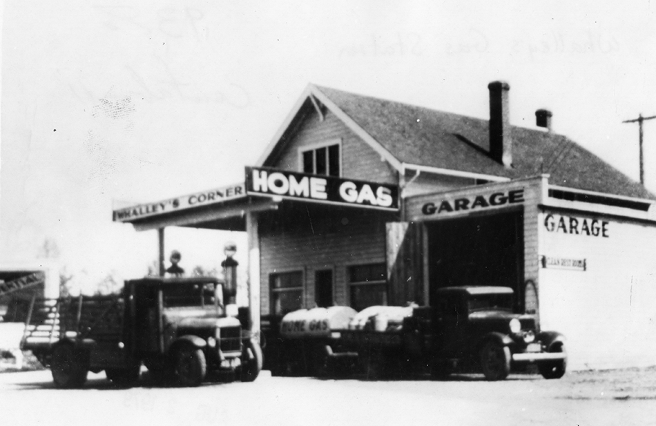 View of Whalley’s Corner Garage with a farm truck and Home Gas truck at pumps